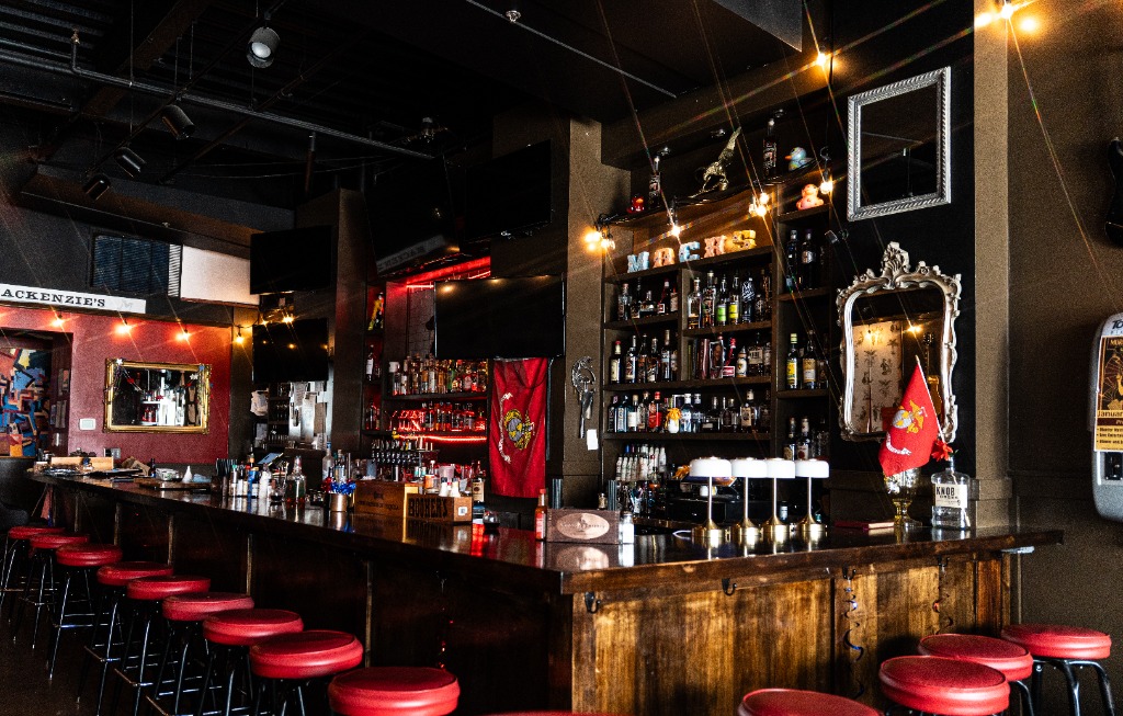 Warm ambient interior of Mackenzie's bar in Old Town Fairfax featuring vintage decor and guitar