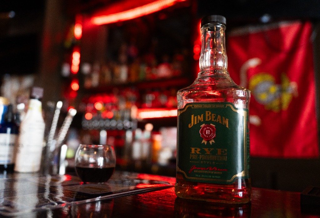 Jim Beam Rye Pre-Prohibition style whiskey bottle on the bar top at Mackenzie's with warm red lighting